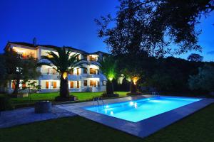 a swimming pool in front of a house at night at Villa Maro in Skopelos Town