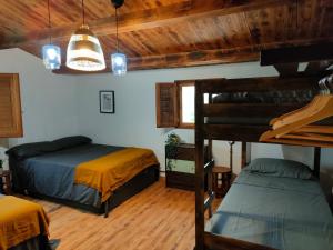 two bunk beds in a room with wooden ceilings at Masia Sisqueta in Els Muntells