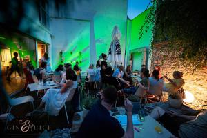 a group of people sitting at tables in a room at Art Hotel in Ljubljana