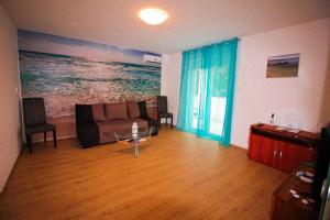 a living room with a couch and a table at Apartman Mirno More in Selce