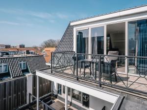 a balcony with a view of a building at Juuls Domburg in Domburg
