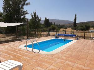 a swimming pool in a yard with a swimming pool at Hospederia La Serrota in Narros del Puerto +33 photos