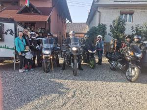 a group of people on motorcycles posing for a picture at Lörincz Vendégház in Corund