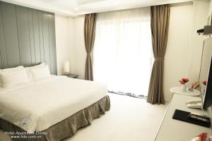 Säng eller sängar i ett rum på Fide Hotel