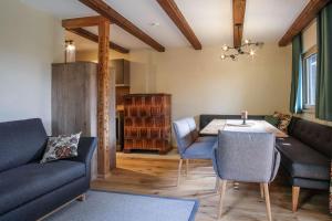 a living room with a couch and a table at Berghaus Turracherhöhe in Turracher Hohe