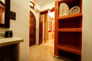 a room with a closet with wooden shelves at Riad Janoub in Tiznit