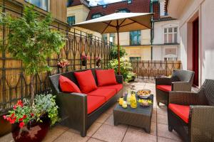 
a living room filled with furniture and a red couch at Buddha-Bar Hotel Prague in Prague
