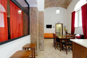 a dining room with red curtains and a table and chairs at Lucky Holidays in Rome