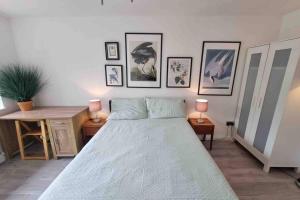 a bedroom with a large bed and some pictures on the wall at The Bungalow in Chesterton