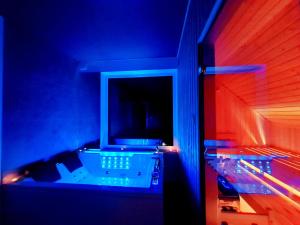 a room with blue and red lights in a room at Bukówka Luksusowa Bacówka in Ochotnica Dolna