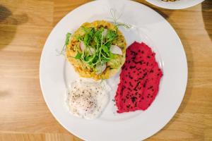 a white plate with food on a wooden table at Designer apartments for City Breaks in Chester in Chester