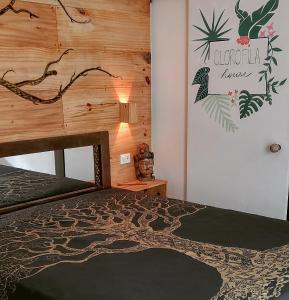 - une chambre avec un lit et un mur en bois dans l'établissement Suite Clorofila House Guest House, à Ubatuba