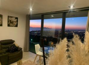 a living room with a view of a city at On the GBay Villa in Gordonʼs Bay