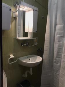 a bathroom with a sink and a mirror at Smeštaj Filipović in Soko Banja +27 photos