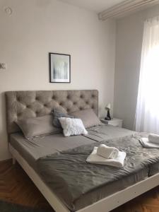 a large bed with two white towels on it at Smeštaj Filipović in Soko Banja
