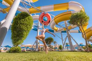a woman is on a roller coaster at a water park at Pickalbatros Aqua Park Resort - Hurghada in Hurghada +181 photos