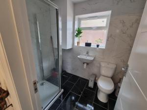 a bathroom with a toilet and a sink and a shower at The Bungalow in Chesterton +17 photos