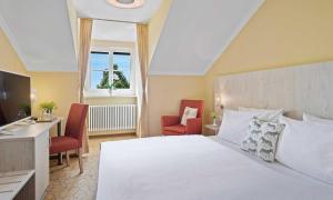 Postel nebo postele na pokoji v ubytování Hotel St Leonhard