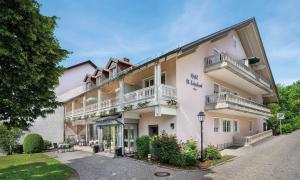 a large white building with balconies on it at Hotel St Leonhard in Bad Griesbach