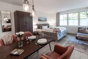 a living room with a table and a couch at Appartementhaus Bellevue Binz in Binz