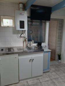 a kitchen with a sink and a counter top at Little Beach House - Free parking in Zandvoort