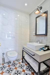 a bathroom with a sink and a toilet and a mirror at Orient Express & Spa by Orka Hotels in Istanbul