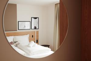 Postel nebo postele na pokoji v ubytování HOMEBOUND APARTMENTS Salzburg City I - contactless check-in
