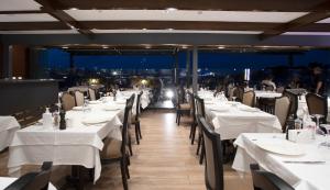 a restaurant with white tables and chairs with a view at Orient Express & Spa by Orka Hotels in Istanbul