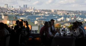 a group of people sitting at a table looking at the city at Orient Express & Spa by Orka Hotels in Istanbul