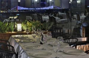 a table with white plates and wine glasses on it at Orient Express & Spa by Orka Hotels in Istanbul