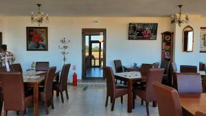 a dining room with wooden tables and chairs at Pensiunea Karola in Păltiniş