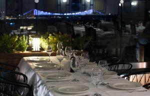a table with plates and wine glasses on it at Orient Express & Spa by Orka Hotels in Istanbul