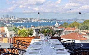 a long table with chairs and a view of the city at Orient Express & Spa by Orka Hotels in Istanbul