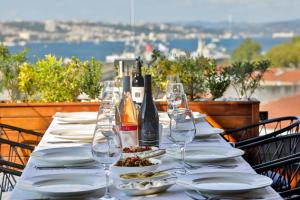 a table with glasses and plates and wine bottles at Orient Express & Spa by Orka Hotels in Istanbul