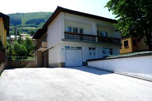 a large white house with a large driveway at Urban Apartment Visoko in Visoko