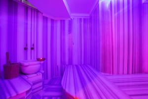 a pink room with a toilet and a sink at Orient Express & Spa by Orka Hotels in Istanbul