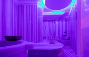 a purple bathroom with a tub and a sink at Orient Express & Spa by Orka Hotels in Istanbul
