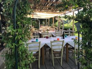 a table and chairs under a pergola at Locanda Montepaolo in Dovadola