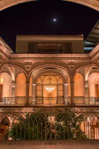 a building with a balcony with a chandelier at Casa Grande Hotel Boutique in Morelia