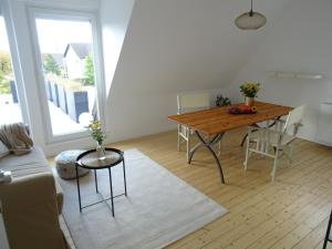 a living room with a table and a couch at FeWo am Deister in Bad Münder am Deister