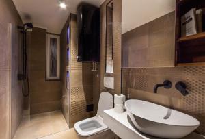 a bathroom with a sink and a toilet at Elite Space in Niš