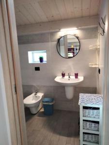 a bathroom with two sinks and a toilet and a mirror at Residenza Flores in Pescara