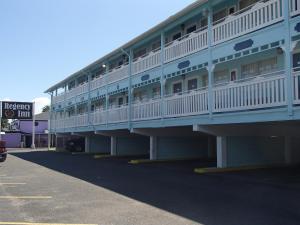 a building with balconies on the side of it at Regency Inn Motel by the Beach in Corpus Christi