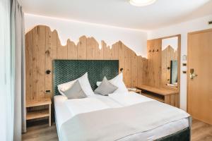 Кровать или кровати в номере Garni Hotel Miara - Your Dolomites Home