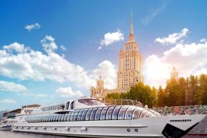 a cruise ship in front of a large building at Radisson Collection Hotel Moscow in Moscow