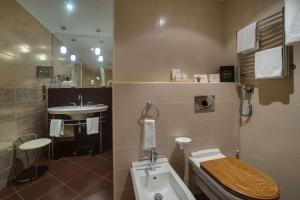 
a bathroom with a toilet and a sink at Radisson Collection Hotel Moscow in Moscow
