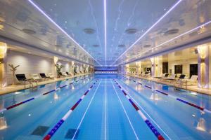 a large swimming pool in a building at Radisson Collection Hotel Moscow in Moscow