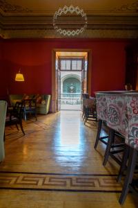 a dining room with red walls and a table and chairs at Casa Grande Hotel Boutique in Morelia
