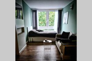 ein Wohnzimmer mit einem Sofa und einem Fenster in der Unterkunft ANSEHEN LOHNT! FeWo in STEINHUDE in Steinhude