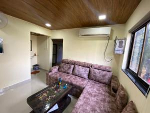 a living room with a couch and a table at Farmhouse in Pune city in Pune